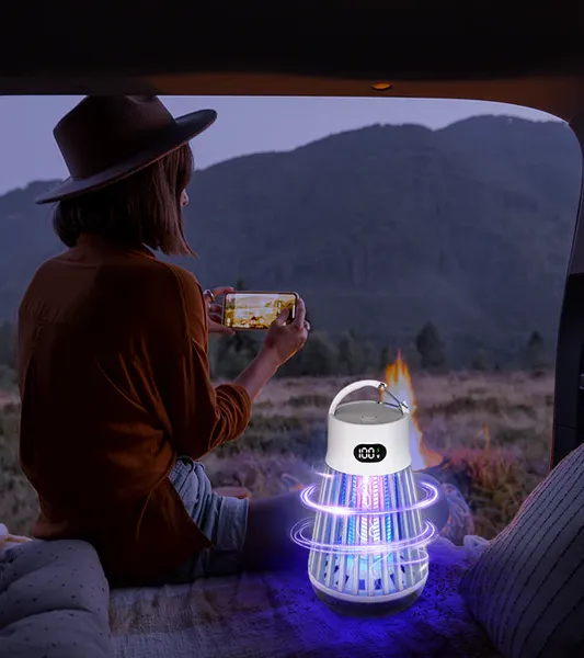 Woman using ZapShield while camping